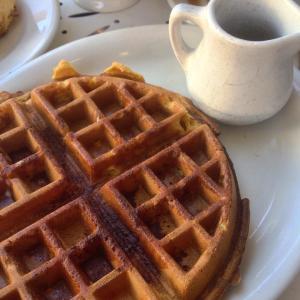 Pumpkin waffle with cinnamon, and maple syrup on the side