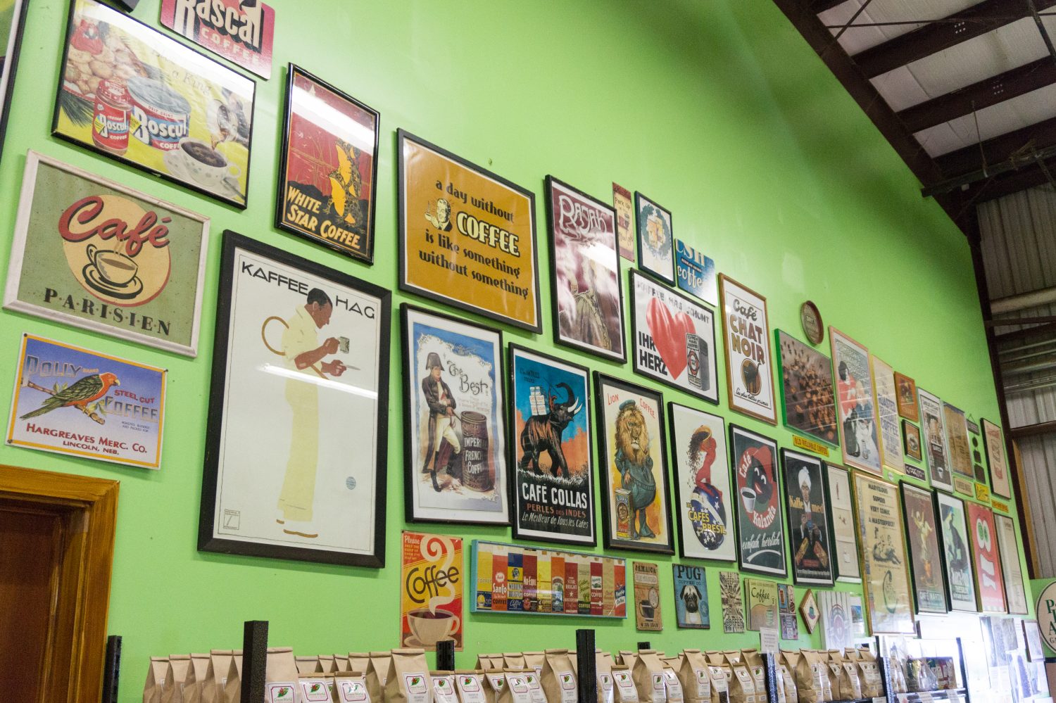 Green wall with framed coffee prints